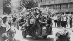 Radom, 1976-06-25. Grupa młodych ludzi jadących akumulatorowym wózkiem z narodową flagą pod gmach Komitetu Wojewódzkiego Polskiej Zjednoczonej Partii Robotniczej (KW PZPR). Fot. PAP/CAF