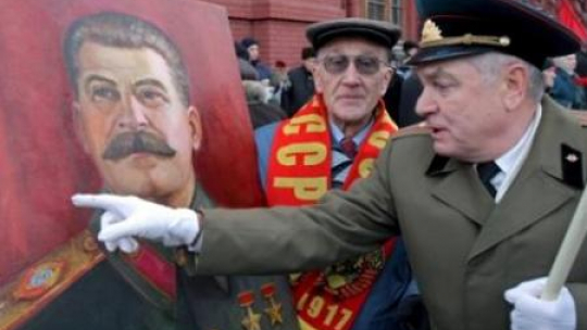 Rosyjscy komuniści z portretem Józefa Stalina koło jego grobu na Placu Czerwonym w Moskwie. Fot. PAP/EPA