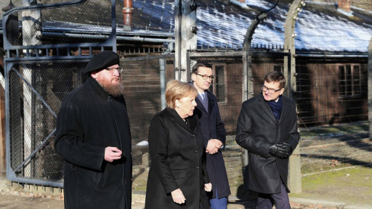 Kanclerz Niemiec Angela Merkel (2L), premier Mateusz Morawiecki (2P), dyrektor Państwowego Muzeum Auschwitz-Birkenau Piotr Cywiński (L) i wicedyrektor Państwowego Muzeum Auschwitz-Birkenau Andrzej Kacorzyk (P) na terenie byłego niemieckiego nazistowskiego obozu zagłady Auschwitz. Fot. PAP/A. Grygiel