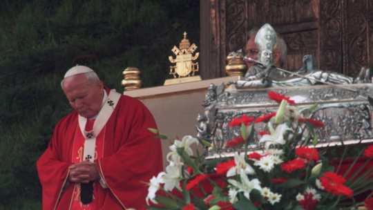 Szósta pielgrzymka papieża Jana Pawła II do Polski. Główne uroczystości z okazji 1000. rocznicy męczeńskiej śmierci św. Wojciecha. Msza święta na placu św. Wojciecha sprawowana pod przewodnictwem Ojca Świętego (na zdjęciu). Z prawej relikwiarz patrona Polski św. Wojciecha. W tle kopia Drzwi Gnieźnieńskich. Gniezno, 03.06.1997. Fot.  PAP/G. Rogiński