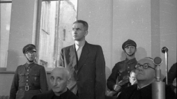 Gubernator okręgu warszawskiego w okresie okupacji Ludwig Fischer na sali sądowej (stoi za ławą obrońców). 1947 r. Fot. PAP/CAF/J. Baranowski