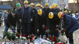 Gdańsk, 16.12.2021. Pracownicy stoczni podczas ceremonii złożenia wieńców na placu Solidarności pod pomnikiem Poległych Stoczniowców i pod tablicą pamięci ofiar stanu wojennego w Gdańsku, 16 bm. Trwają uroczyste obchody 51. rocznicy Grudnia '70. Fot. PAP/A. Warżawa
