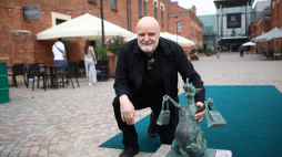 Andrzej Mleczko przy figurce smoka na krakowskim Kazimierzu, fot. PAP/Ł. Gągulski