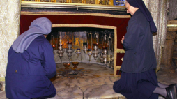 Zakonnice modlą się przed srebrną gwiazdą wskazującą dokładne miejsce narodzin Jezusa w Grocie Narodzenia pod Bazyliką Narodzenia Pańskiego w Betlejem. Fot. 