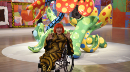 Japońska artystka Yayoi Kusama pozuje przed rzeźbami z serii "Kwiaty, które kwitną o północy" i "Kwiaty, które zakwitną jutro" w Narodowym Centrum Sztuki w Tokio w 2017 roku. Fot. PAP/EPA/FRANCK ROBICHON 