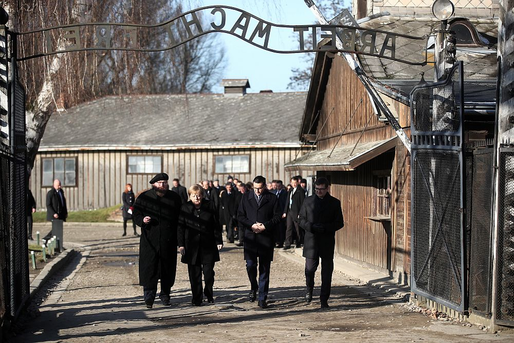 Kanclerz Niemiec Angela Merkel (2L), premier Mateusz Morawiecki (2P), dyrektor Państwowego Muzeum Auschwitz-Birkenau Piotr Cywiński (L) i wicedyrektor Państwowego Muzeum Auschwitz-Birkenau Andrzej Kacorzyk (P) na terenie byłego niemieckiego nazistowskiego obozu zagłady Auschwitz. Fot. PAP/Ł. Gągulski