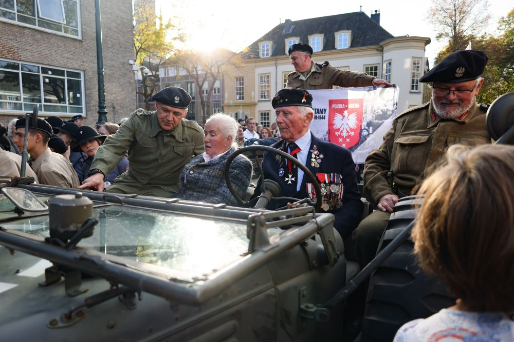 Obchody 80. rocznicy wyzwolenia Bredy. Weteran kpt. Eugeniusz Niedzielski (C) podczas przejazdu na Grote Markt w Bredzie. Fot. PAP/A. Zawada