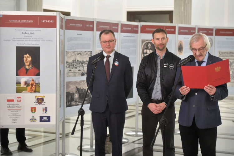 Warszawa, 11.01.2023. Astronauta ESA Sławosz Uznański (C), wicemarszałek Sejmu Ryszard Terlecki (P) i poseł Partii Republikańskiej Arkadiusz Czartoryski (L) na otwarciu wystawy „Mikołaj Kopernik: 1473 – 1543”. Fot. PAP/R. Pietruszka 