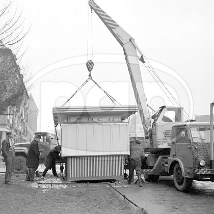 Gdańsk, 12.1970. Ustawianie na Targu Drzewnym, koło Domu Prasy, nowego kiosku Zjednoczenia Upowszechniania Prasy i Książki Ruch w miejscu spalonego podczas wydarzeń grudniowych 1970. Fot. PAP/KFP/Zbigniew Kosycarz