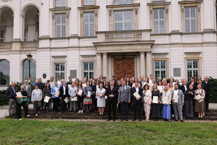 Wiceminister kultury i dziedzictwa narodowego Marek Krawczyk (C), zastępca dyrektora Narodowego Centrum Kultury Michał Rydzewski (C-L) oraz kierownik Działu Stypendialnego Narodowego Centrum Kultury Bogumiła Berdychowska (C-P) na zbiorowym zdjęciu uczestników gali wręczenia dyplomów stypendystom programu MKiDN "Gaude Polonia" przed Pałacem Rzeczypospolitej w Warszawie. Fot. PAP/Albert Zawada